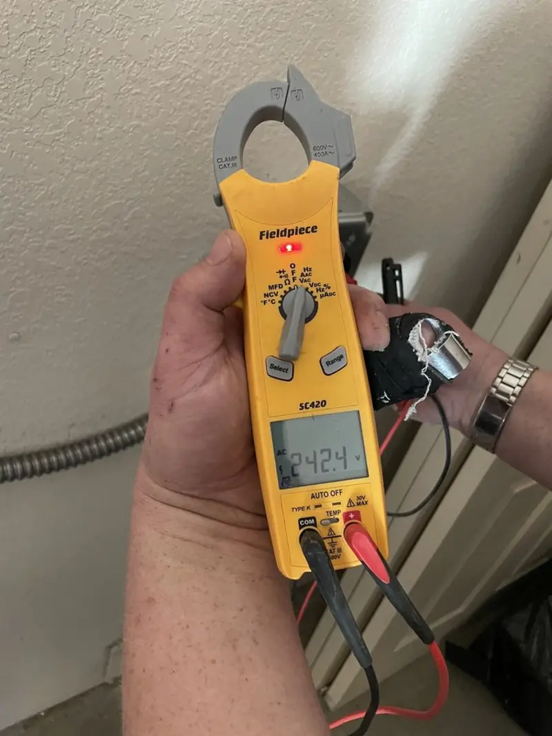 Voltage testing with clamp meter during Ceiling Fan Installation in Johnson Creek